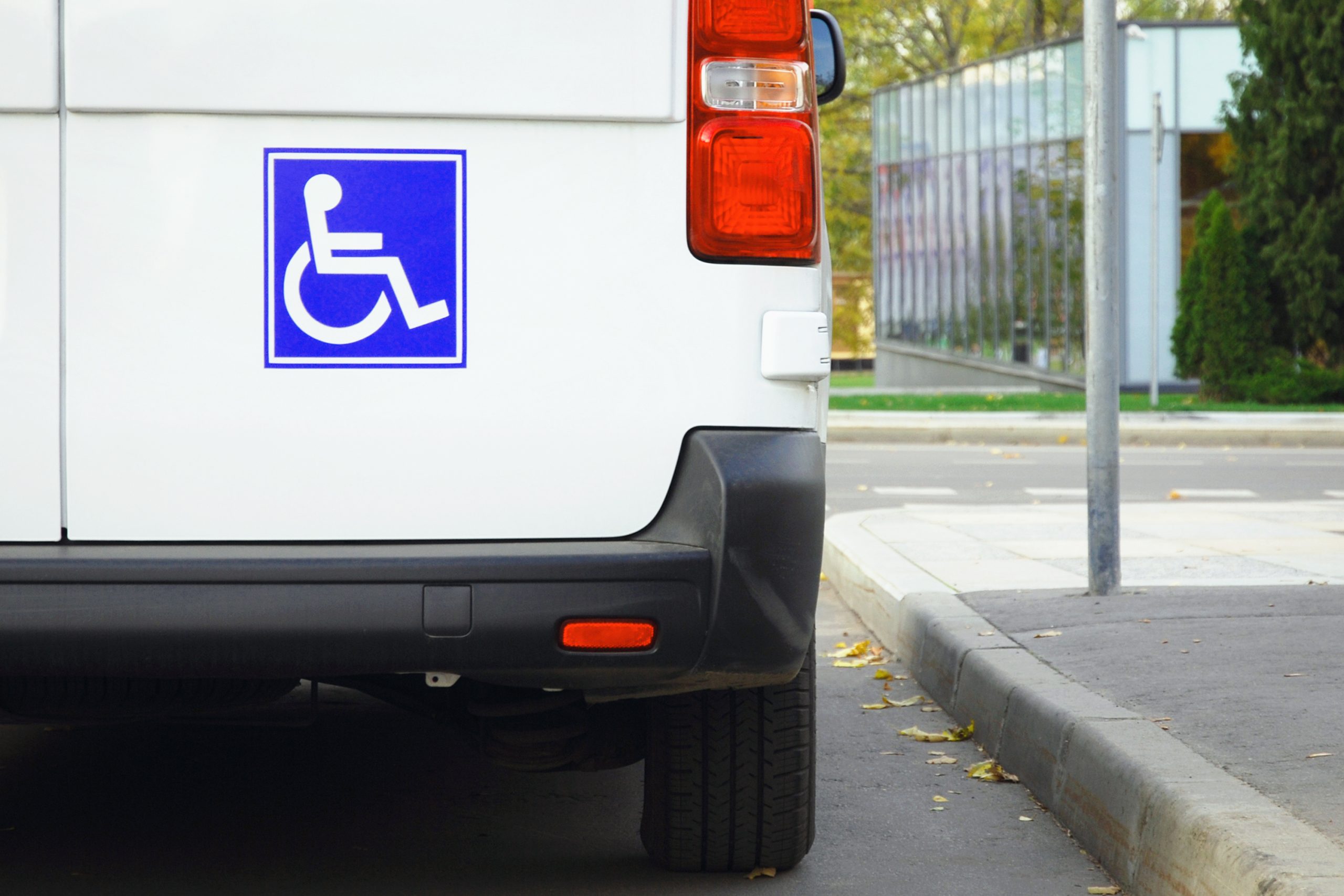 a taxi van with a disability sign on the back